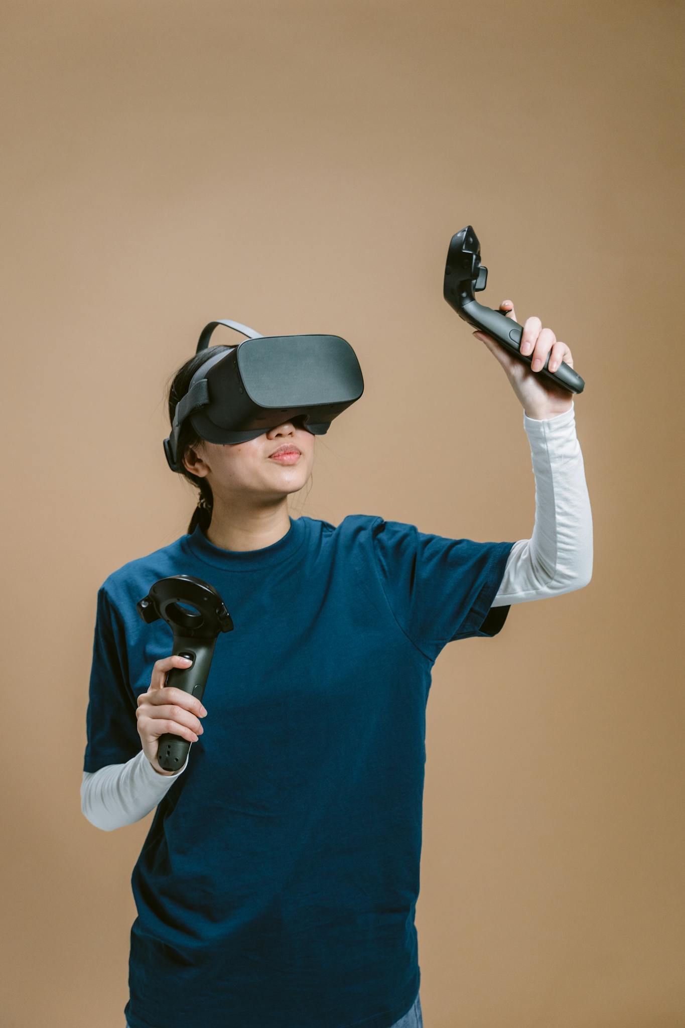 Individual immersed in a VR game with headset and controllers on a brown background.